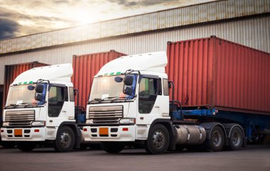 Semi Trailer Trucks Parked Loading Dock at Dock Warehouse. Delivery Trucks Shipping Containers. Distribution Warehouse. Cargo Freight Trucks Transport. Warehouse Logistics.