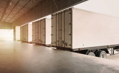 Cargo Container Trailer Trucks Parked Loading Dock at Dock Warehouse. Shipping Trucks. Cargo Freight Trucks Transport. Warehouse Logistics.