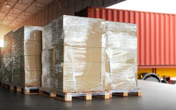 Packaging Boxes Wrapped Plastic Stacked on Pallets Loading into Cargo Container. Shipping Trucks. Supply Chain Shipment. Distribution Supplies Warehouse. Freight Truck Transport Logistics.