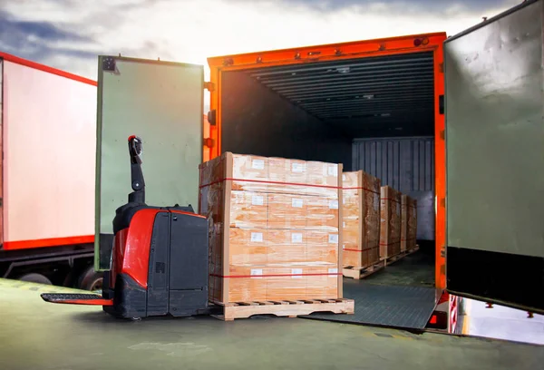 Packaging Boxes Wrapped Plastic Stacked on Pallets Loading into Cargo Container. Electric Forklift Pallet Jack Loader. Supply Chain. Shipment. Supplies Warehouse. Freight Truck Transport Logistics.