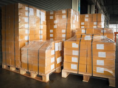 Packaging Boxes Wrapped Plastic Stacked on Pallets in Storage Warehouse. Supply Chain. Storehouse Distribution. Cargo Shipping Supplies Warehouse Logistics.