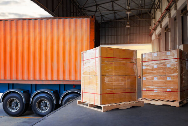 Packaging Boxes Wrapped Plastic Stacked on Pallets Loading into Cargo Container. Shipping Trucks. Supply Chain Shipment. Distribution Supplies Warehouse. Freight Truck Transport Logistics.