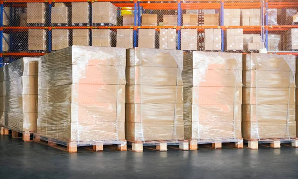 Packaging Boxes Wrapped Plastic Stacked on Pallets in Storage Warehouse. Supply Chain. Storehouse Distribution. Cargo Shipping Supplies Warehouse Logistics.