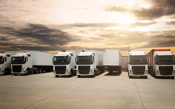 Semi TrailerTrucks Parked Lot with The Sunset Sky. Shipping Container. Delivery Transit. Engine Diesel Trucks. Lorry Tractor. Industry Freight Trucks Logistics Cargo Transport.