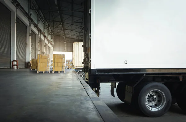 Shipping Cargo Container Trucks Parked Loading at Dock Warehouse. Goods Pallets. Delivery Trucks. Distribution Warehouse. Cargo Freight Trucks Transport. Warehouse Logistics.