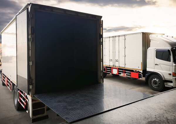 Cargo Trucks Parked Loading at Dock Warehouse. Shipping Cargo Container Delivery Trucks. Distribution Warehouse. Freight Trucks Cargo Transport. Warehouse Logistics.