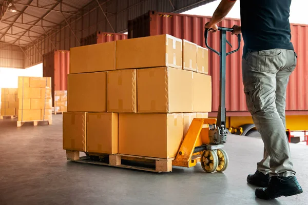 Workers Unloading Packaging Boxes on Pallets in Warehouse. Cartons Cardboard Boxes. Shipping Warehouse. Delivery. Shipment Goods. Supply Chain. Supplies Distribution Warehouse Logistics