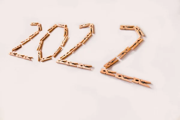 Number 2022 is made of small wooden clothespins on a white background. — Stock Photo, Image