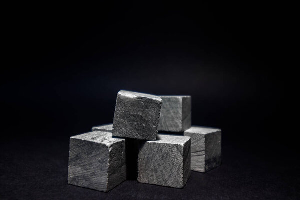 Whiskey cubes lie on a dark background. Stones for cooling drinks.