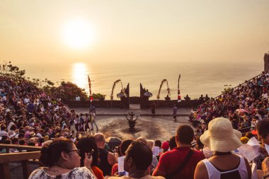 Bali - Indonesia - 10.21.2015: Tourists waiting for the Kecak Fire Dance in the Uluwatu Temple amphitheater at sunset