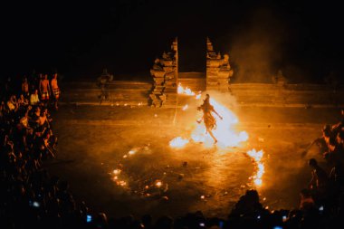 Bali - Indonesia - 10.21.2015: Kecak dancers performing the Fire Dance in the Pura Luhur Uluwatu amphitheater, Uluwatu Temple a Balinese Hindu sea temple on the hill