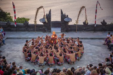 Bali - Indonesia - 10.21.2015: Kecak dancers performing the Fire Dance in the Pura Luhur Uluwatu amphitheater, Uluwatu Temple a Balinese Hindu sea temple on the hill