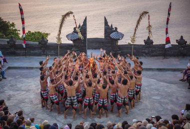 Bali - Indonesia - 10.21.2015: Kecak dancers performing the Fire Dance in the Pura Luhur Uluwatu amphitheater, Uluwatu Temple a Balinese Hindu sea temple on the hill