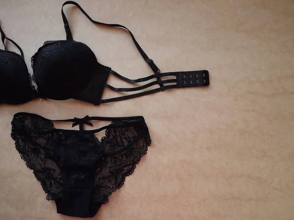 Black Sexy Womens Underwear Set on Beige Background — Stock Photo, Image
