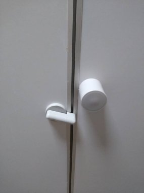 Tuvalet kapısının mandalı beyaz renkte.