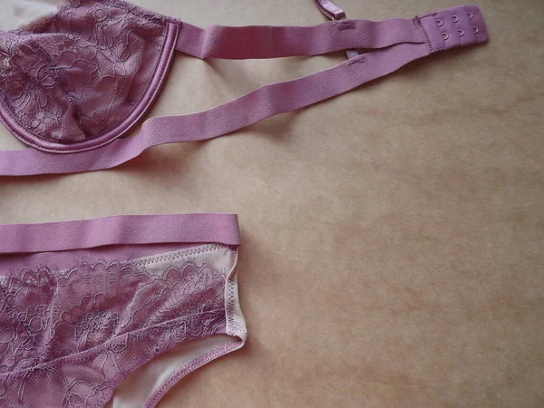 Pink lilac Guipure Sexy womens Underwear set on beige Background — Stock Photo, Image