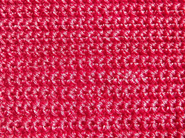 Knitted fabric of pink, crimson color close-up as a background — Stock Photo, Image
