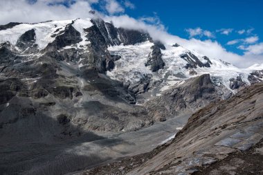 Mountain landscape with snow-capped peaks and blue sky