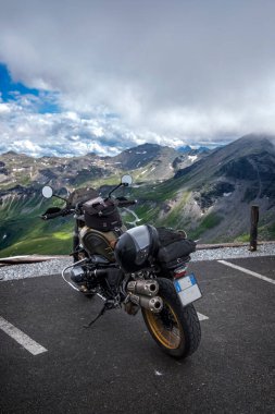Mountain landscape with motorcycle parked on the edge of the ravine