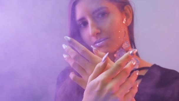 Mädchen blickt in die Kamera und streichelt sanft ihre Hände — Stockvideo