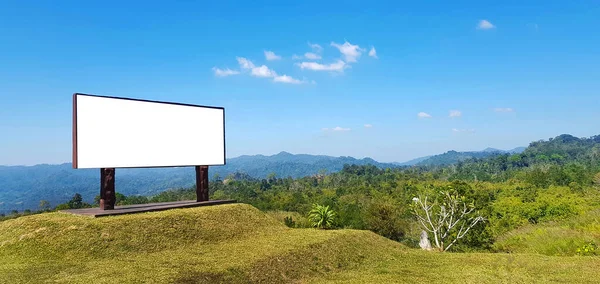 Empty or mockup sign for add or fill wording or text with forest or jungle, mountain, clear blue sky and cloud background at national park. Beautiful natural and Advertisement or Announcement concept