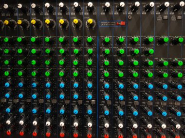 Top view of colorful button on mixer or equalizer device for control sound or volume. Flat lay of electronic device and Technology.