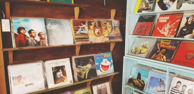 Samut Sakhon, Thailand - July 15, 2022: Many record or dish put on wooden shelf for sale. Collection of Vintage object. Musical or music concept. 