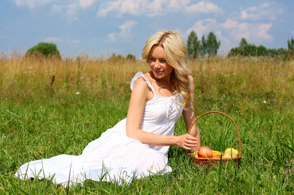 Very beautiful girl with a basket of fruit — Stock Photo, Image