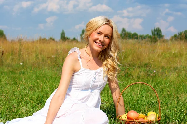 Very beautiful girl with a basket of fruit — Stock Photo, Image