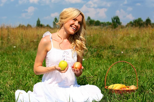 Meisje met een mand fruit — Stockfoto