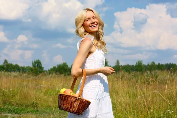 Beautiful young blond woman in a white sundress — Stock Photo, Image