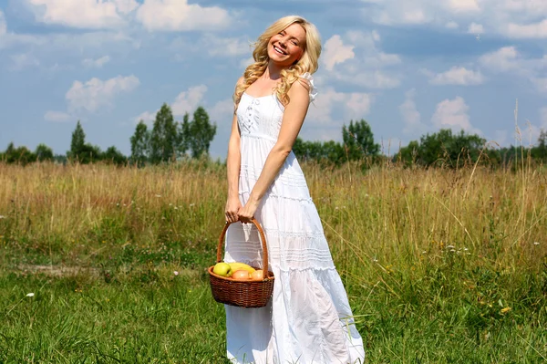 Beautiful young blond woman in a white sundress — Stock Photo, Image
