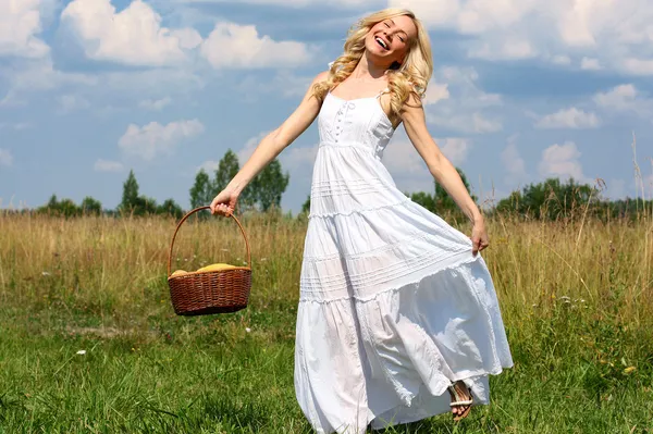 Beautiful young blond woman in a white sundress — Stock Photo, Image