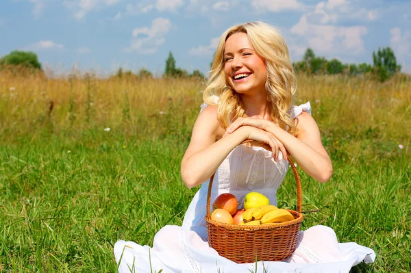 Girl with a basket of fruit Stock Photo