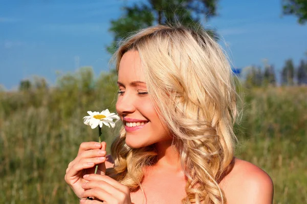 Blonde girl with a flower — Stock Photo, Image