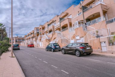Torrevieja 'da tipik evleri, tatil evleri olan modern yerleşim yerleri. Birkaç araba park etmiş. İspanya