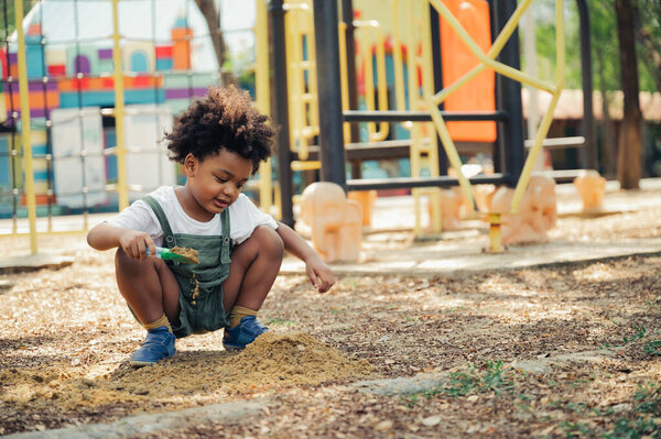 Black people African American child playing sand in playground