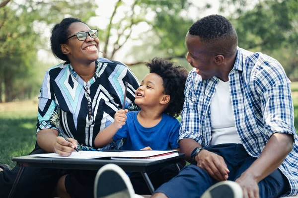 Mutlu eğitim ödevleri, çocuk bahçedeki siyahi aile.