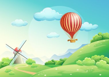 Yaz alanları bir değirmen ve bir balon s gösteren resim