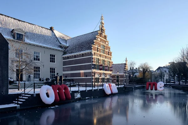 Museum Flehite, Historical museum of Amersfoort and Eemland in the Netherlands. Cold winter evening with ice on the canal and because of corona measures the words, OM ARM ME. Wich means EMBRACE ME.