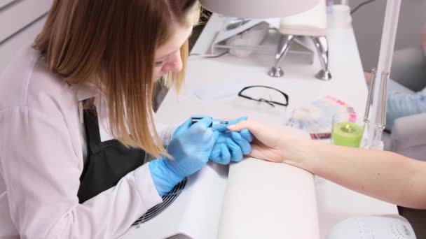 Meisterin Blauen Schutzhandschuhen Die Einer Kundin Schönheitssalon Ihre Arbeit Mit — Stockvideo