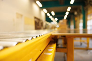 Fully automated logistics warehouse with a conveyor belt. Background is blurred. It is a modern storage. High quality photo