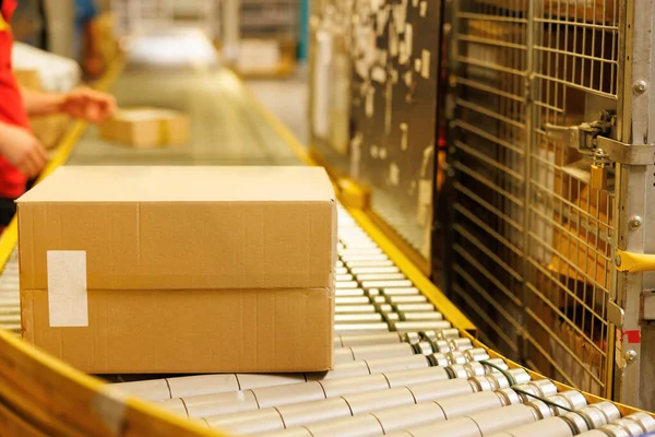 Boxes on conveyor belt in a big warehouse. High quality photo