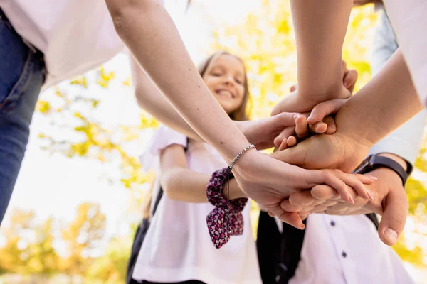 A happy and united family in front of the school start the new school year. High quality photo