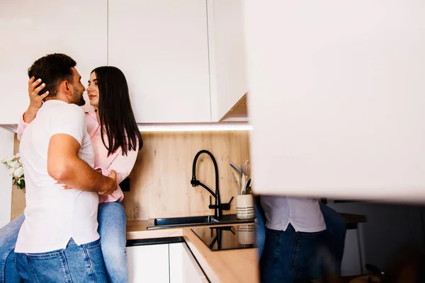 Happy couple in love standing in the kitchen romantically. Big love in their eyes. High quality photo