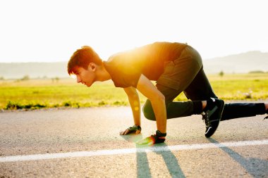 Sport. Sprinter leaving starting blocks on the running track. Healthy lifestyle concept. High quality photo