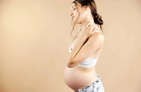 Side View Pregnant Woman Lower Back Pain Beige Background High — Fotografia de Stock