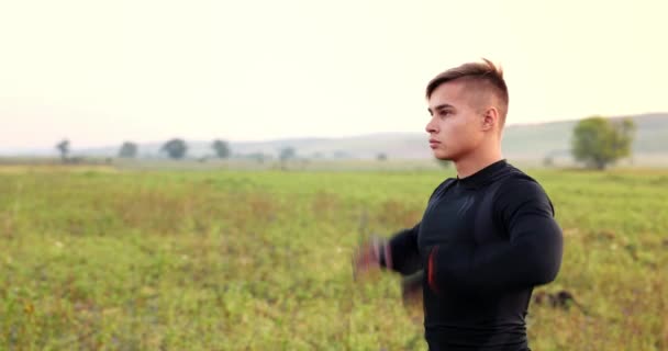 Young Male Athlete Stretches His Arms Prepare His Body Workout — Stockvideo