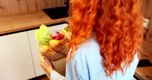 Beautiful Red Haired Girl Puts Basket Vegetables Kitchen Table High — Vídeo de Stock