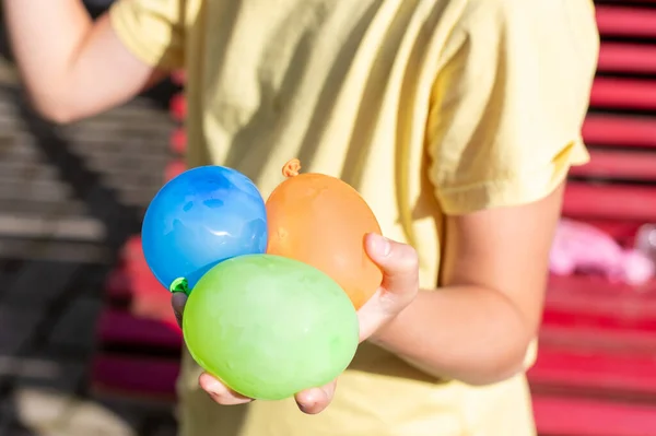 child holding  balloon water bombs